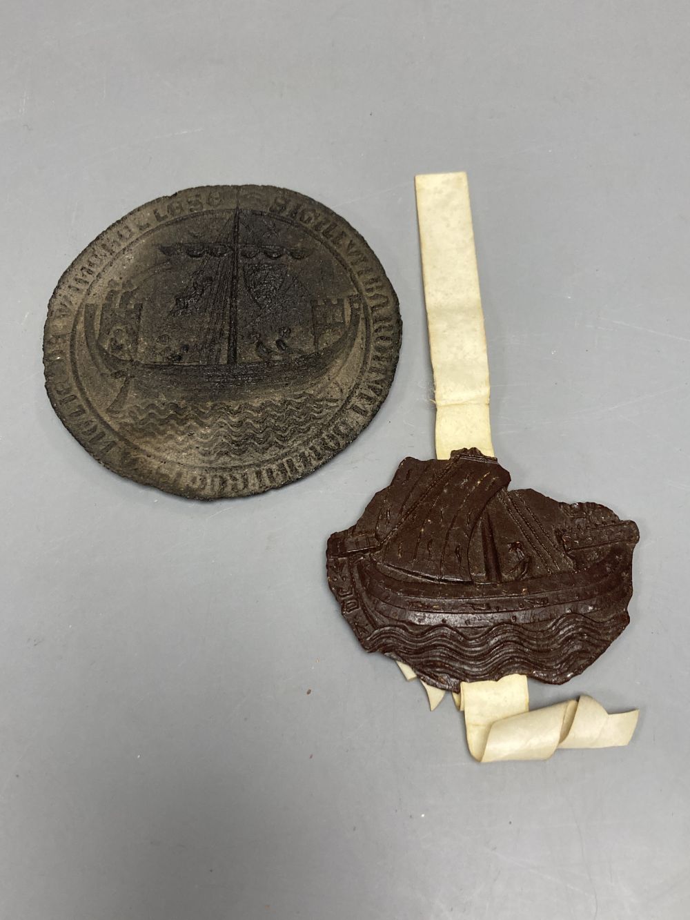A 13th/14th century wax seal fragment of the Barony of Rye and an impression of the seal of Winchelsea, largest 8.5cm